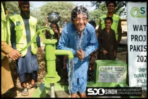 Boy washing face from small handpumps from SDO in village